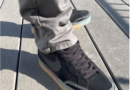 The Nike SB Pogo Plus Premium (Black Gum) worn on feet with grey pants