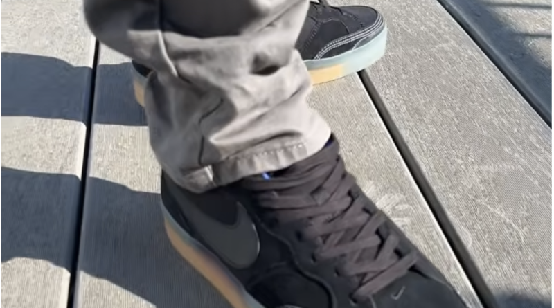 The Nike SB Pogo Plus Premium (Black Gum) worn on feet with grey pants