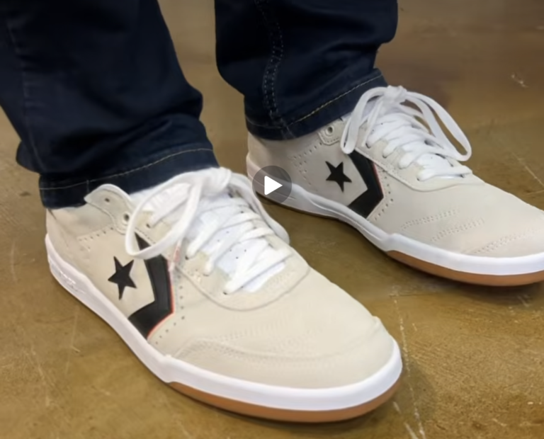 The CONS Louie Lopez Pro 2 Suede in Egret/White/Orange on feet worn with straight fit dark blue jeans