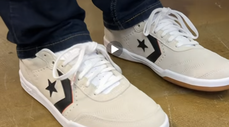 The CONS Louie Lopez Pro 2 Suede in Egret/White/Orange on feet worn with straight fit dark blue jeans